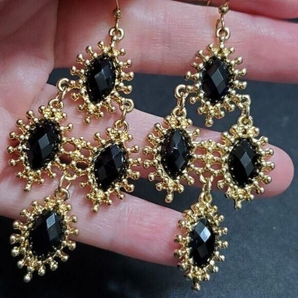 Gold tone dangling earrings with black beads